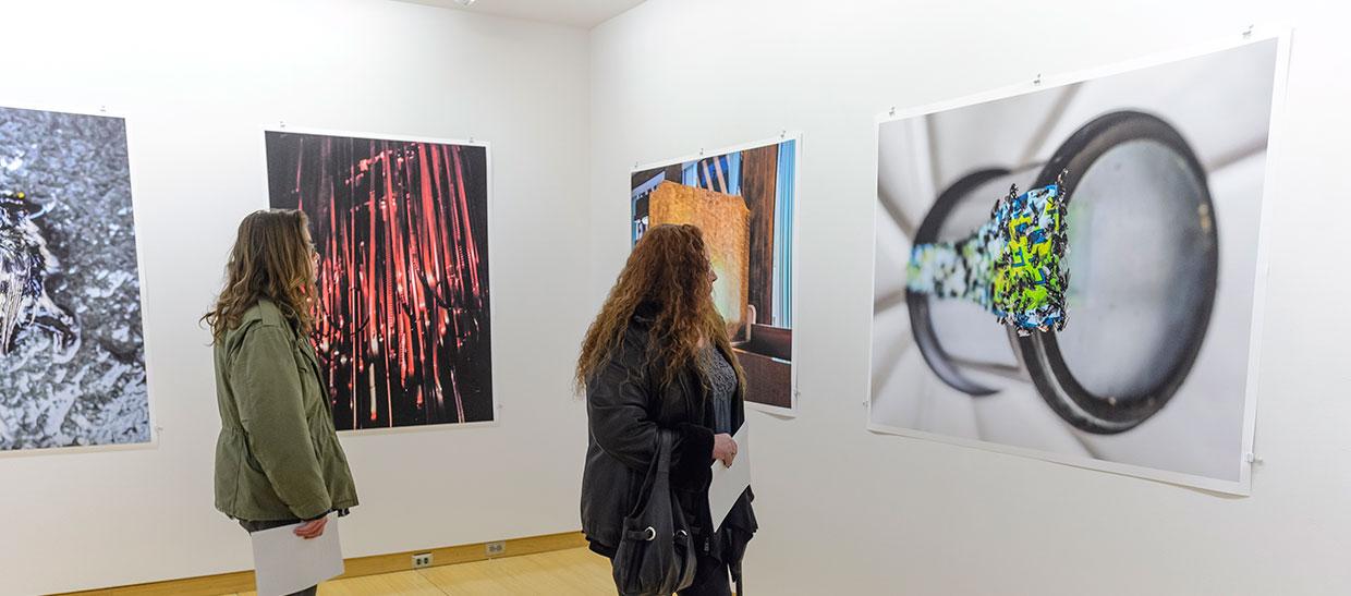 Students looking at artwork in the gallery